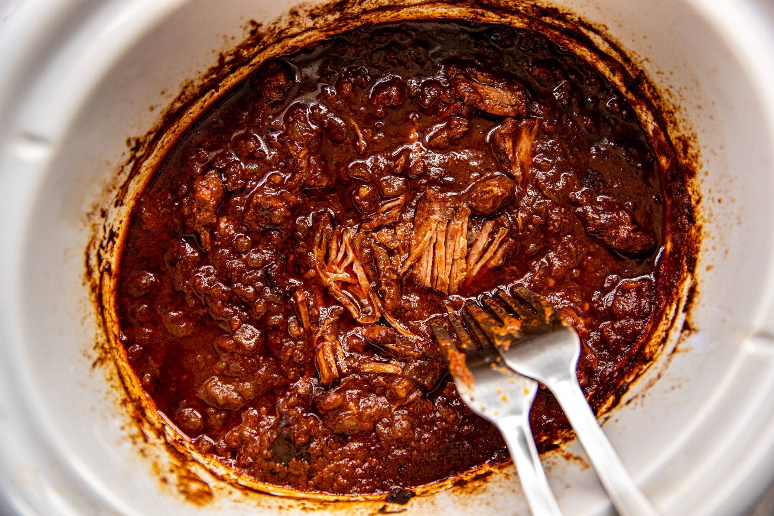 Shredding beef in a slow cooker.