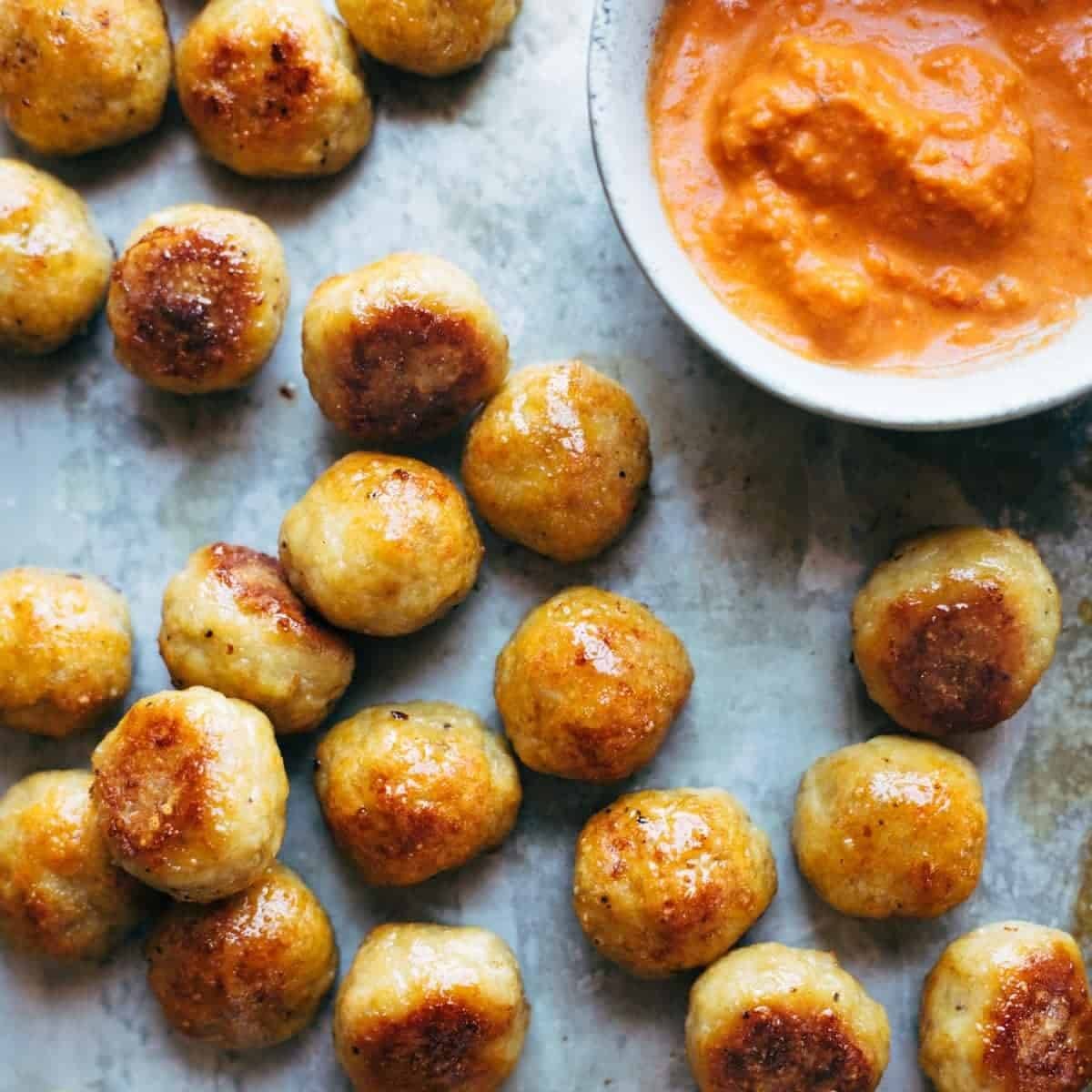 Chicken meatballs on a sheet pan.