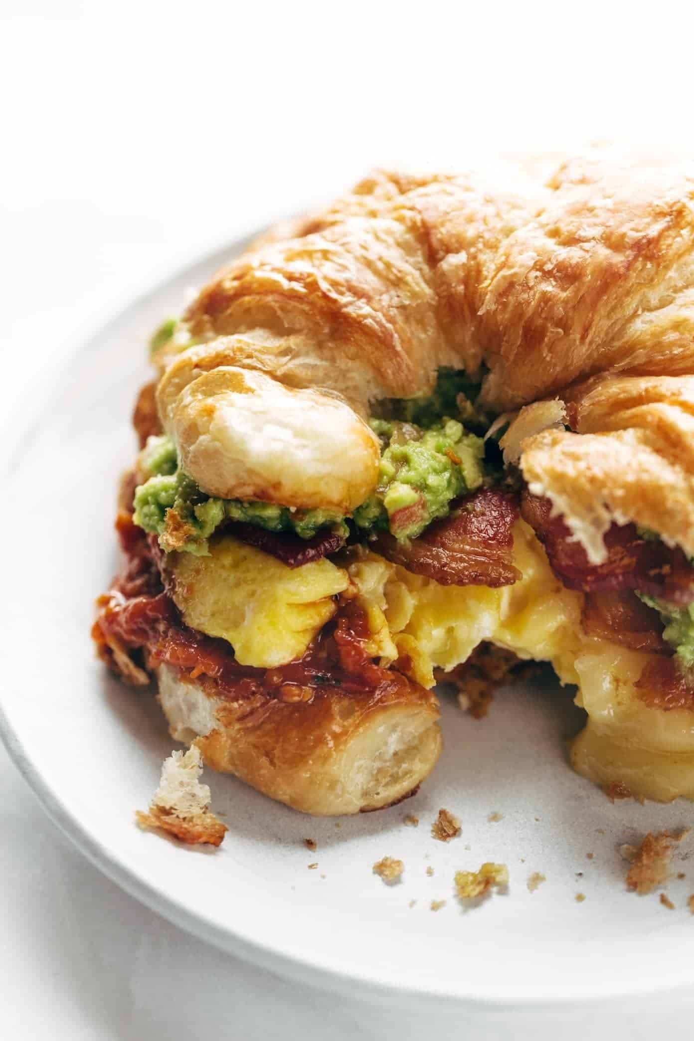 Breakfast sandwich with a bite taken out of it.