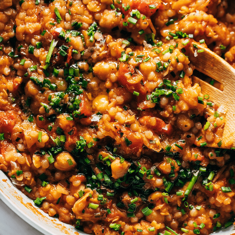 Tomato and pear couscous in a skillet.