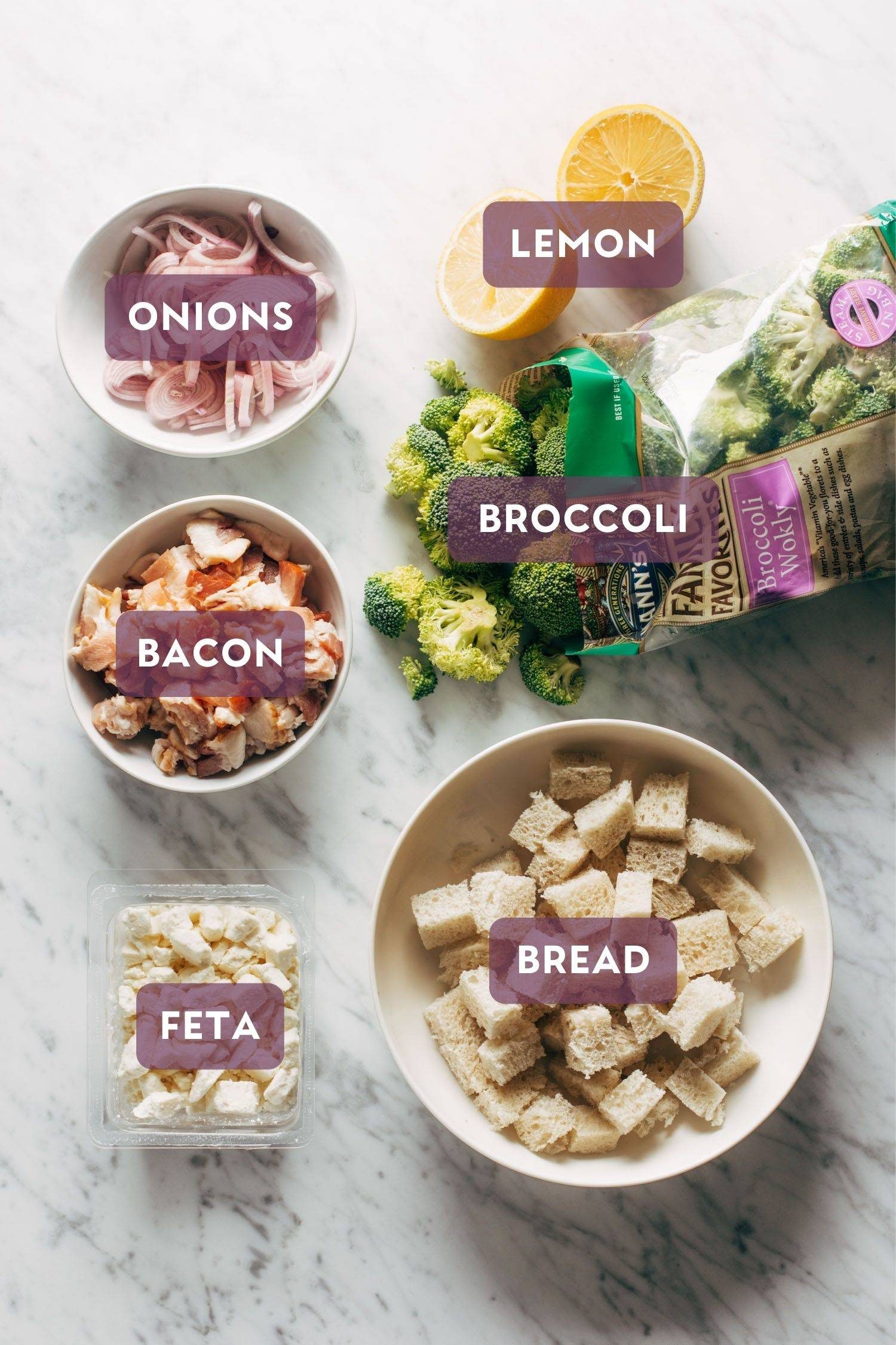 Ingredients in bowls for Roasted Broccoli Salad. Each ingredient has a purple label over the top with the name of the ingredient.