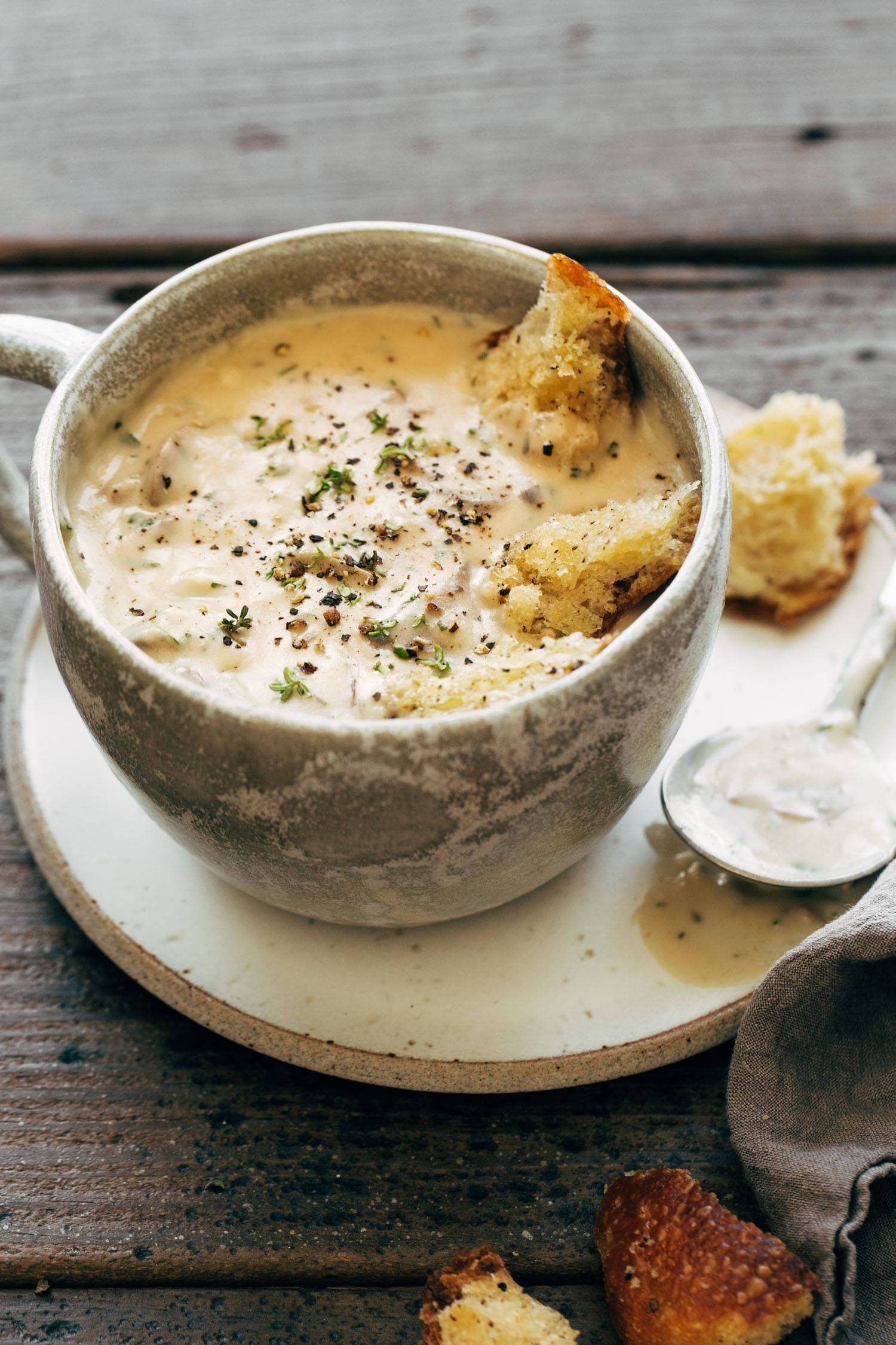 Creamy mushroom soup in a bowl with croutons.