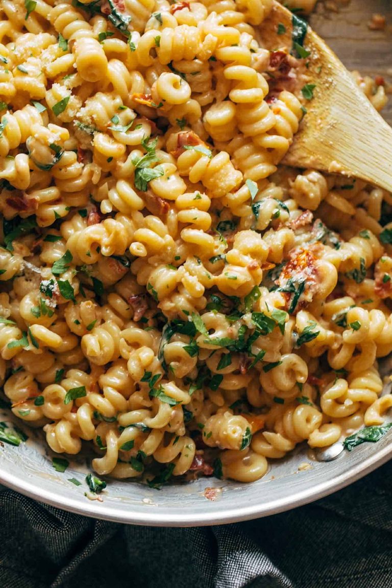 Creamy garlic sun-dried tomato pasta in a skillet.