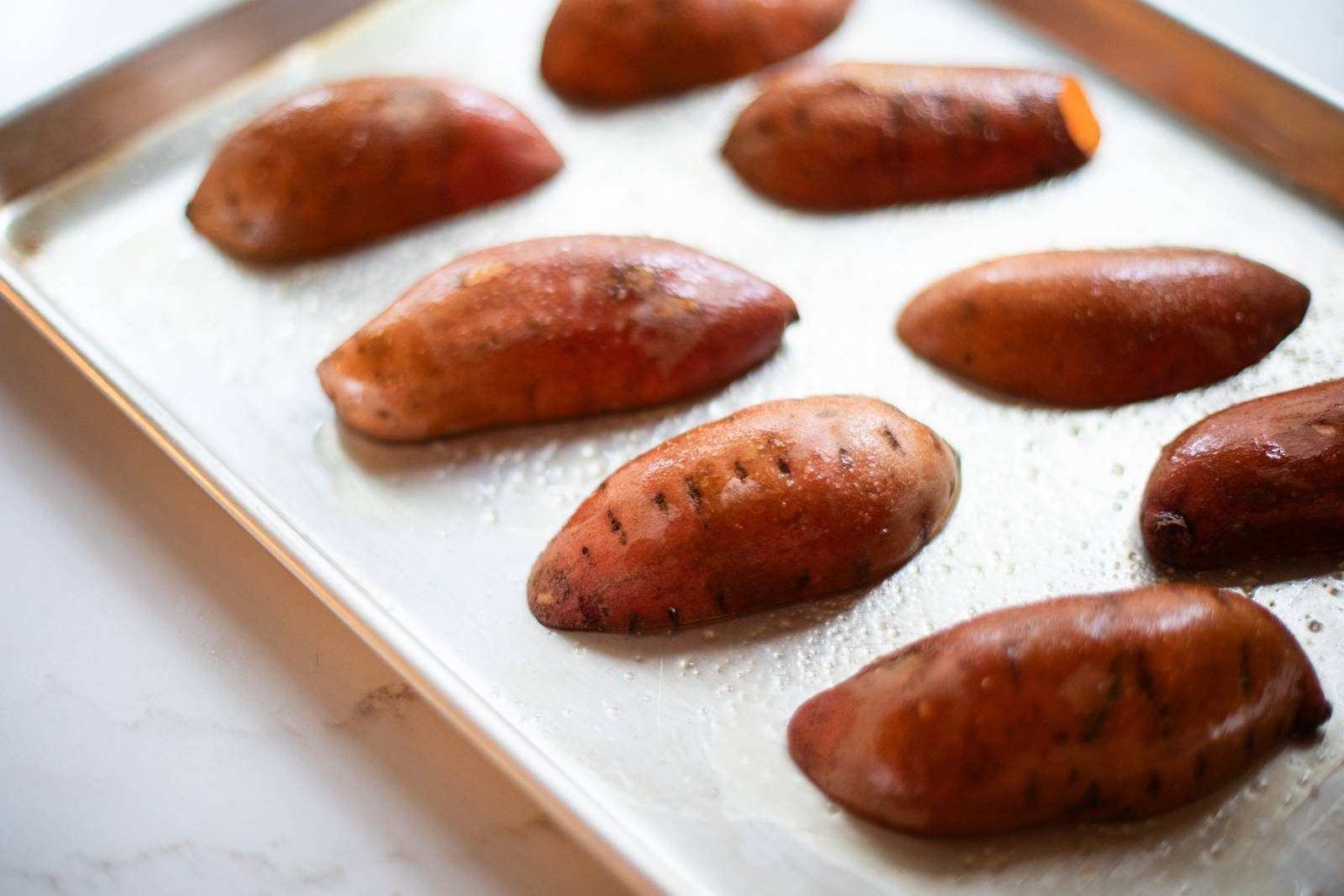 Sweet potatoes on a sheet pan.